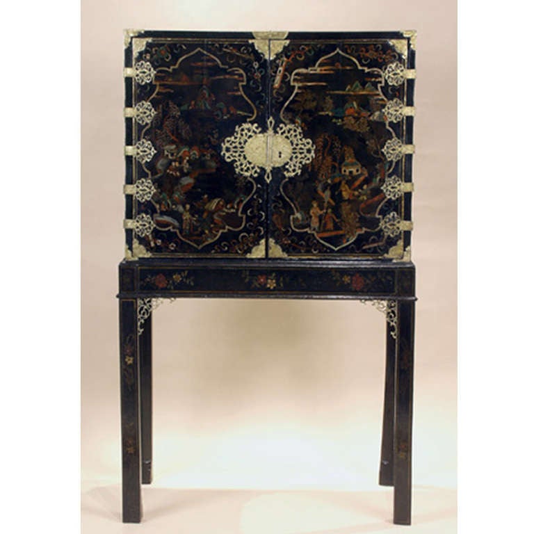 Chinese Export gilt bronze-mounted gold decorated and painted black chest on stand.