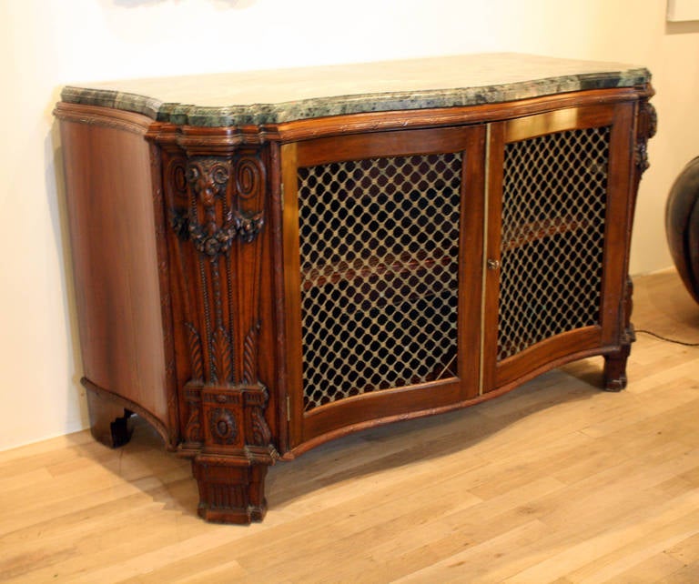 Neoclassical mahogany cabinet, with Verde antico marble top and brass grill,
North German, circa 1770.