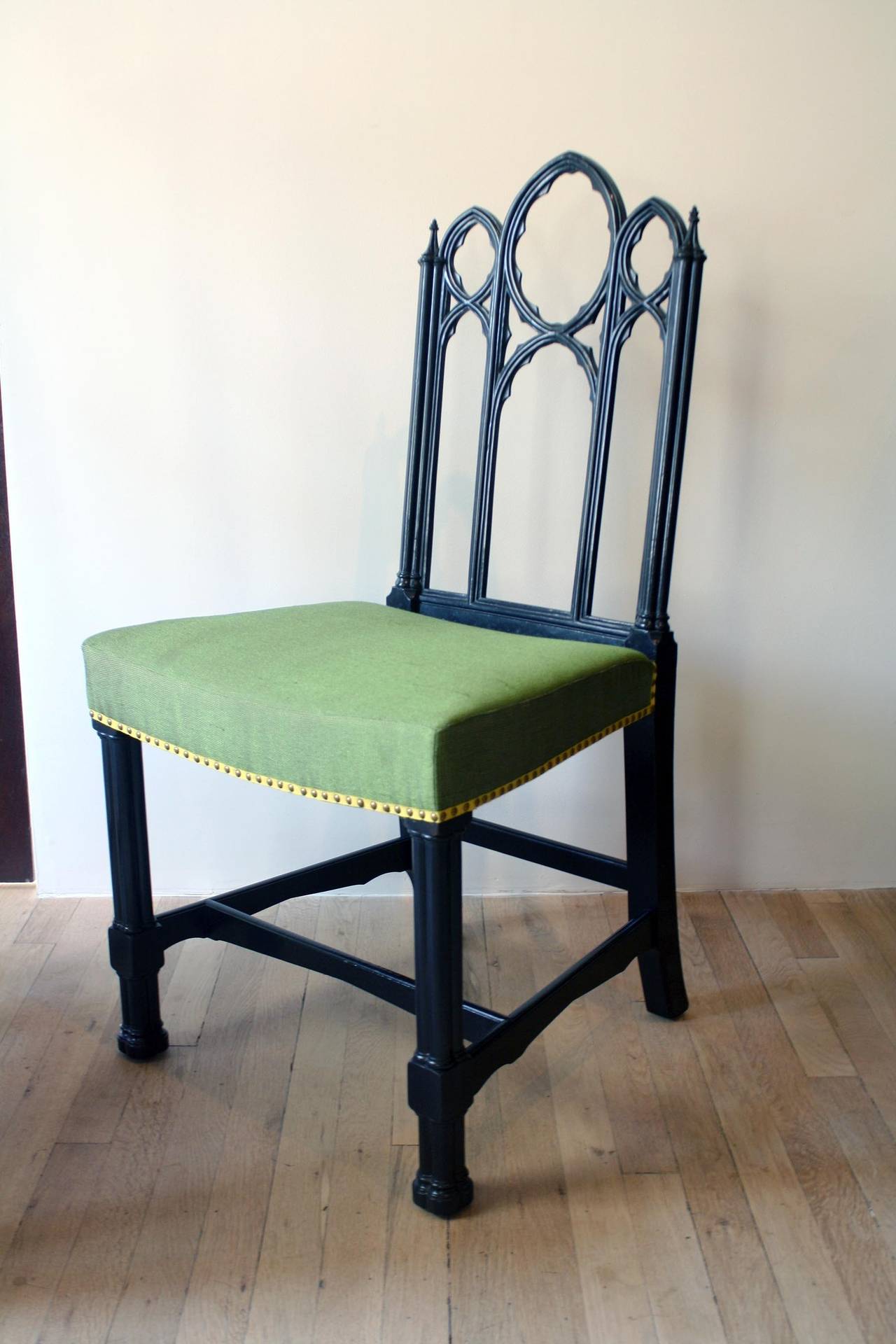 Set of four ebonized Gothic side chairs. Label from Irving & Casson - A.H. Davenport, Co., Boston and New York.