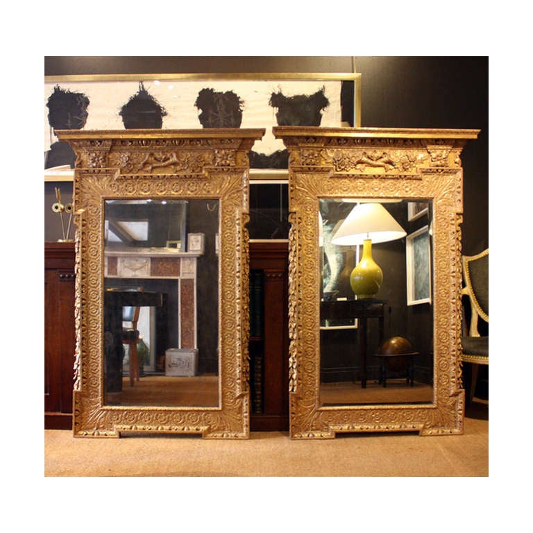 Wonderful rare pair of early Georgian giltwood pier mirrors in the manner of William Kent (English, 1685-1748).