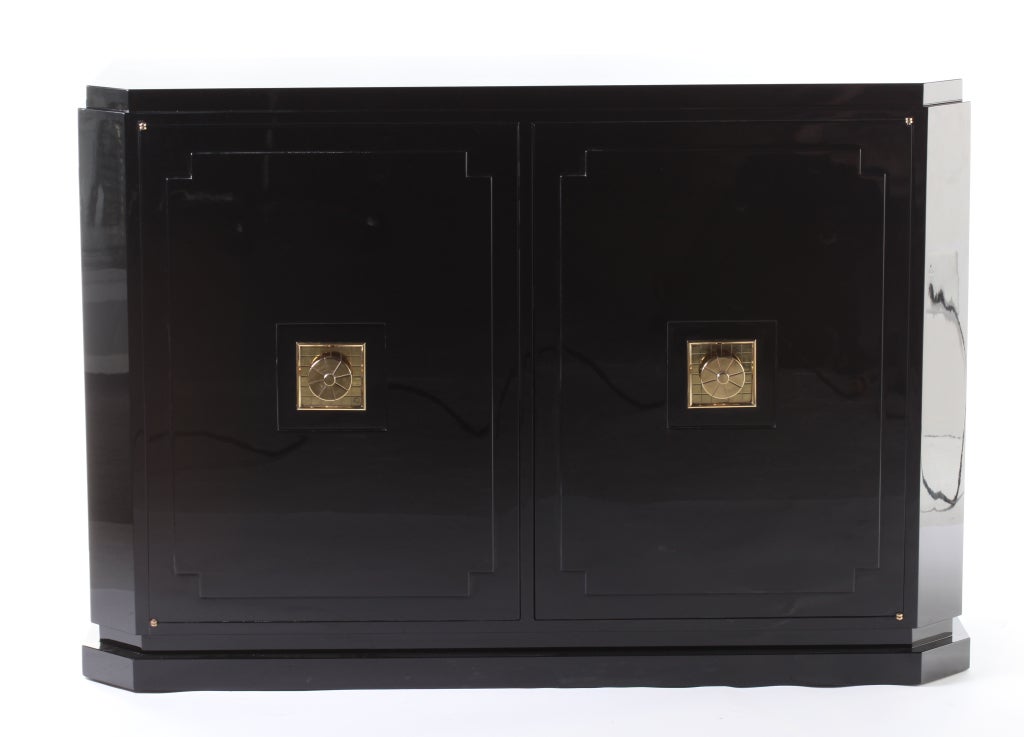 Tommi Parzinger for Parzinger Originals black lacquer buffet/ commode with raised front and side panels and iconic brass hardware. Cabinet features camel lacquer interior with 5 drawers on one side and 2 adjustable shelves on the other.