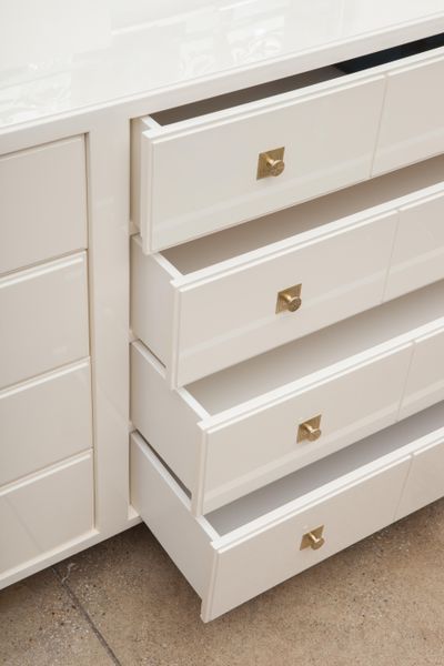 Exceptional cream lacquered double dresser with iconic brass hardware, designed by Tommi Parzinger/Parzinger Originals.