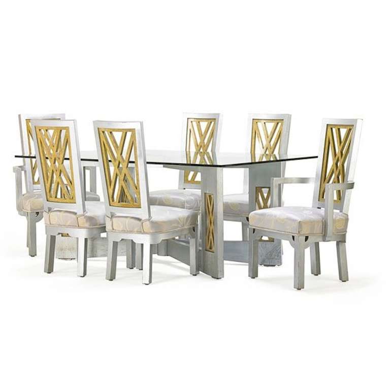 Fantastic 1960s Chinoiserie influenced dining set in silvered and gilded wood with polychromed details. Set includes four side chairs and two arm chairs with gilded fretwork backs and a stately dining table with a glass top. In fantastic original