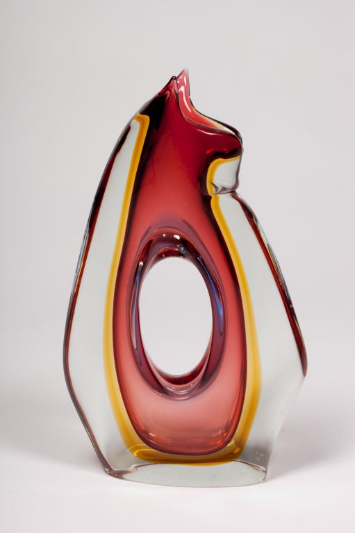 Exceptional stylized feline Murano Glass vase with center oval opening in tones of violet, red and yellow encased in a clear glass.