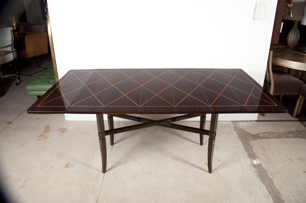 Exceptional mahogany dining table with an inlaid harlequin pattern in sycamore. Includes three extensions which are 9 1/4