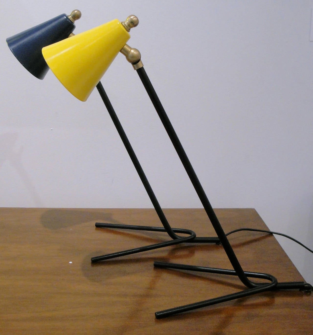 Small yellow and dark blue nightstand/ table lamps. Black painted new metal structure. Adjustable shades on a brass pivot.
Can be purchased separately $600 per piece.