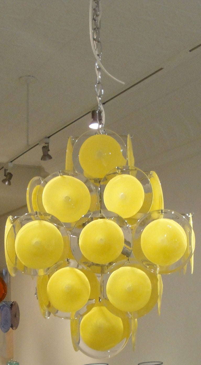 Italian Mid-century Murano glass chandelier. Five tiers of clear round discs with yellow circles. New chromed metal structure. 