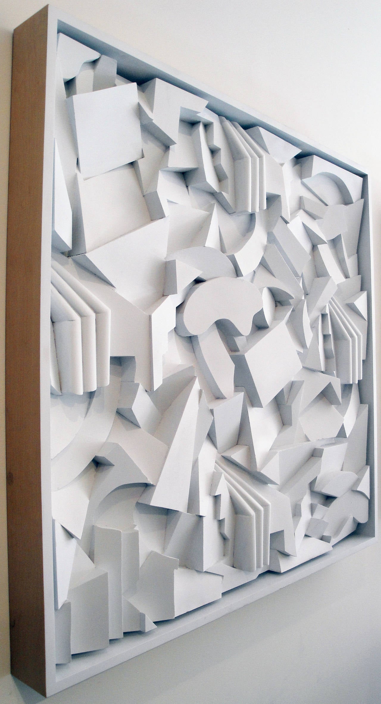 Three dimensional, sculptural piece. White painted wooden elements, framed.
Created by Kazumi Yoshida.