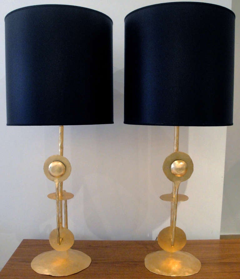 Pair of large Italian lamps. Hand-hammered and gilded wrought iron table lamps, black silk shades with gold insides. Rewired for the American market.