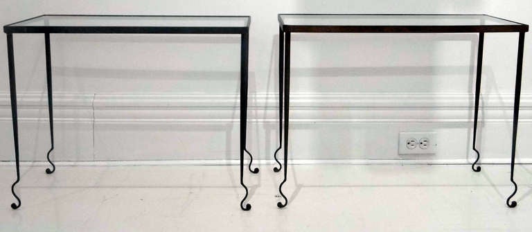 Exquisite French iron base tables from 30's. The rectangular glass top raised on tapered cylindrical legs terminating with scrolled feet.

Published in: Decoration Au'jourd'hui No 16 1936 cover illustration of the tables.