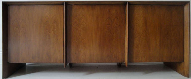 Three door credenza by R. Gibbings for Widdicomb. Natural walnut in excellent original condition. Two compartments with three drawers each, one with three shelves.