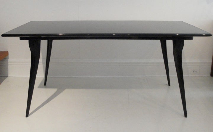 Very elegant, black lacquered, high gloss dining table with tapering legs.