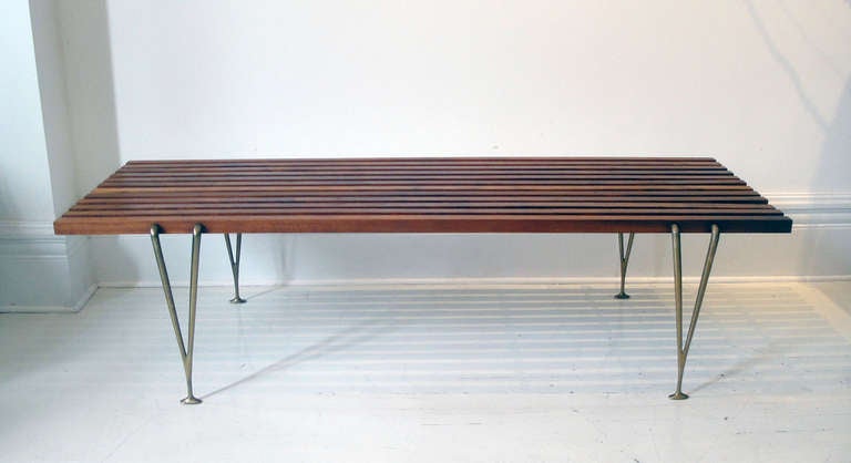 'Suspended Beam' bench designed and manufactured by Hugh Acton. Made of American walnut and cast bronze.