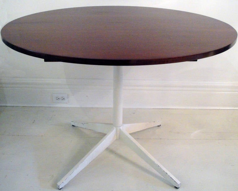 Round dining table by George Nelson for Herman Miller. Teak top with white enameled metal structure.