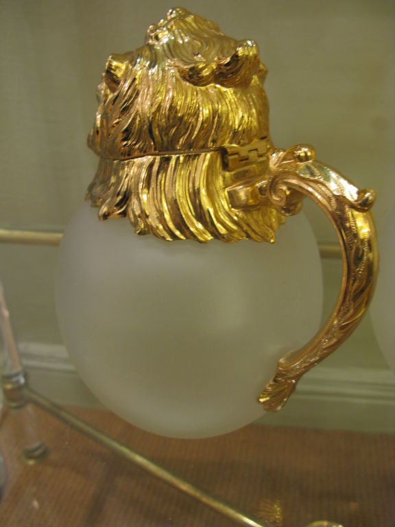 20th Century Pair of Polished Brass and Frosted Glass Lion's Head Pitchers