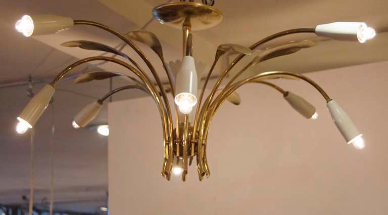 Beautiful example of Stilnovo sputnik, with solid brass leaves polished to perfection with cream enamel. A stand out piece.
Takes 8 E-14 base bulbs, up to 40 watts per arm. All new wiring. Pictured using 12 watt bulbs.