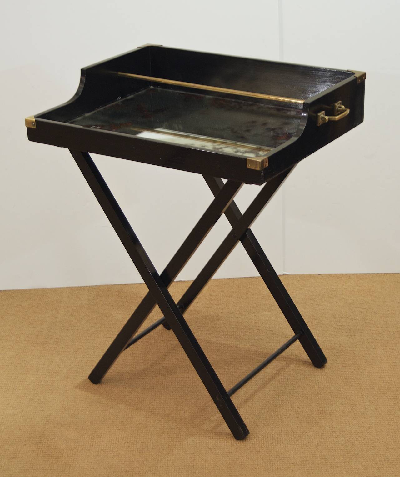 Black lacquer bar with removable tray top with mirrored antique glass and brass detail. Elegant and useful addition to all decors.