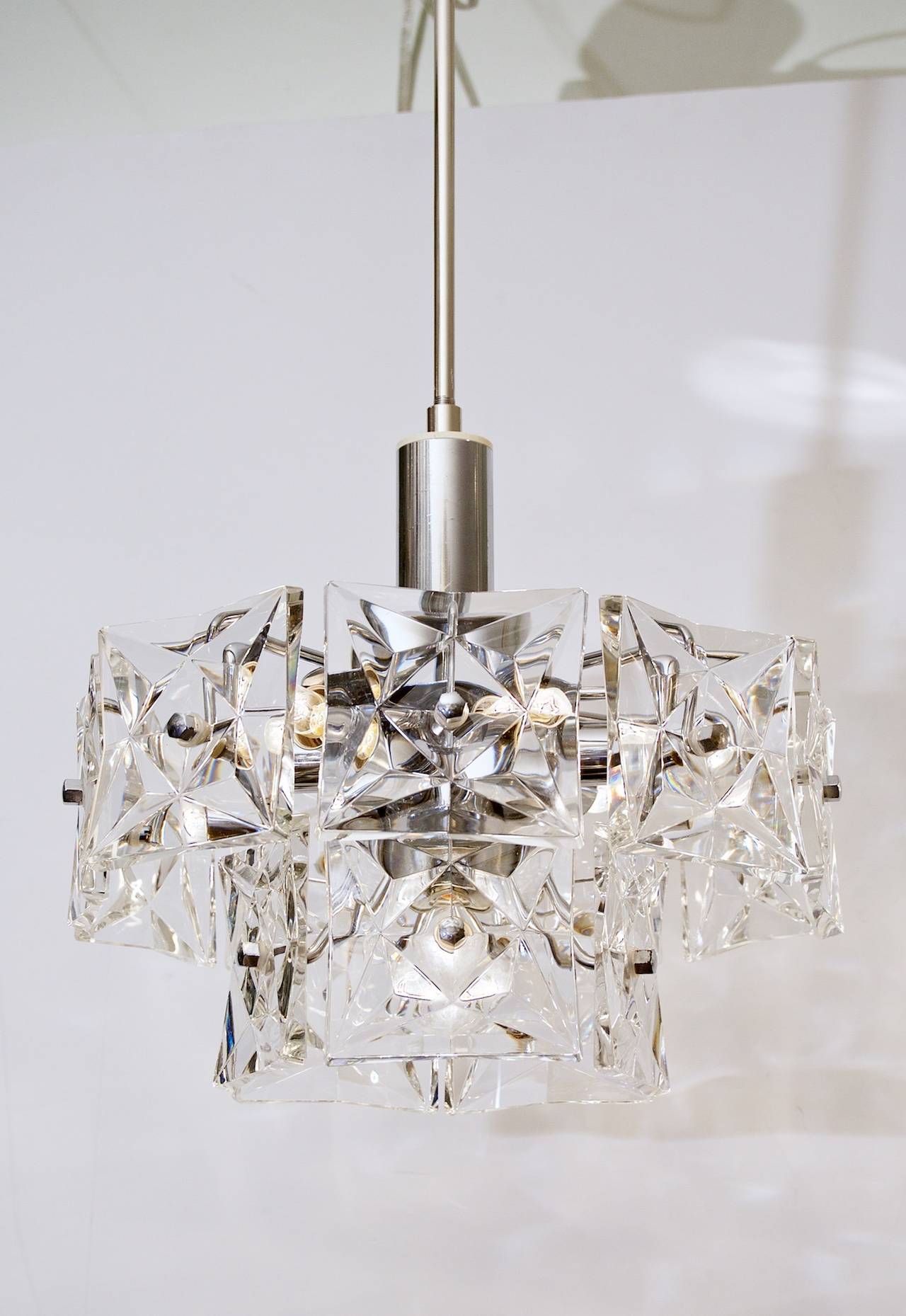 The scale and generous light of these excellent chrome-plated Kinkeldey chandeliers make them a perfect fit for use in hallways, kitchens, and a wide variety of other interior spaces.

Takes six E-14 base and one medium base bulb up to 40 watts