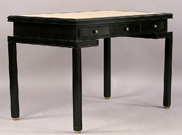 James Mont style ebonized desk has a beautiful cream leather inset top, three drawers and a pull out panel.