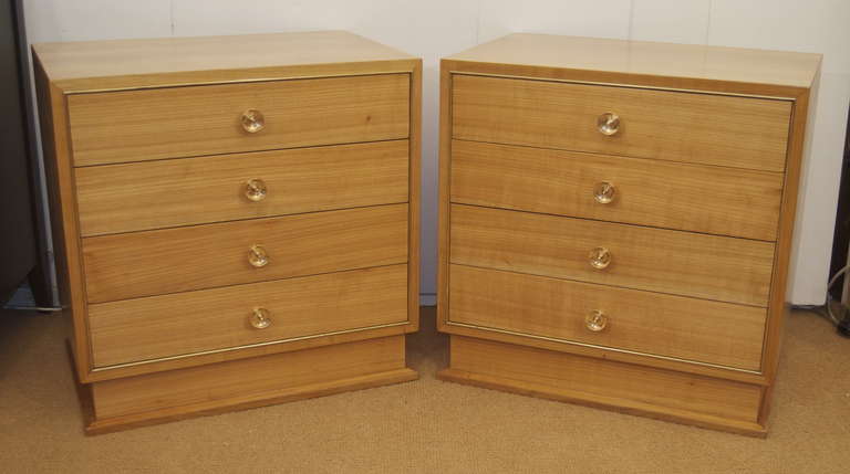 A well proportioned pair of tables with 4 drawers; minimal brass trim surrounds the drawers with unusually shaped brass pulls on the drawers. Simple lines make this a great addition to all decors.

Refinished.