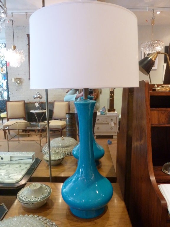 This beautiful peacock blue glazed ceramic table lamp is the perfect scale for making a color statement in your space.