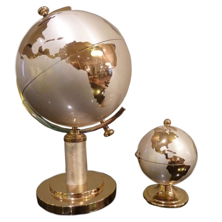 Unique pair of steel and brass cigarette holder and lighter set. The globe opens to display individual vessels for cigarettes. The small globe opens to display a fully-functioning lighter. This set in excellent condition and a rare find.