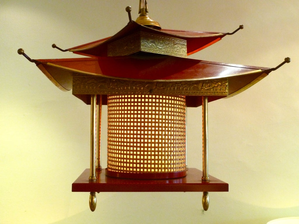 This unusual lantern has intricately detailed brass, rattan and paper shade, and a gorgeous radio flyer red finish.  With one standard socket bulb and an adjustable height chain, it will bring ambiance to your space.