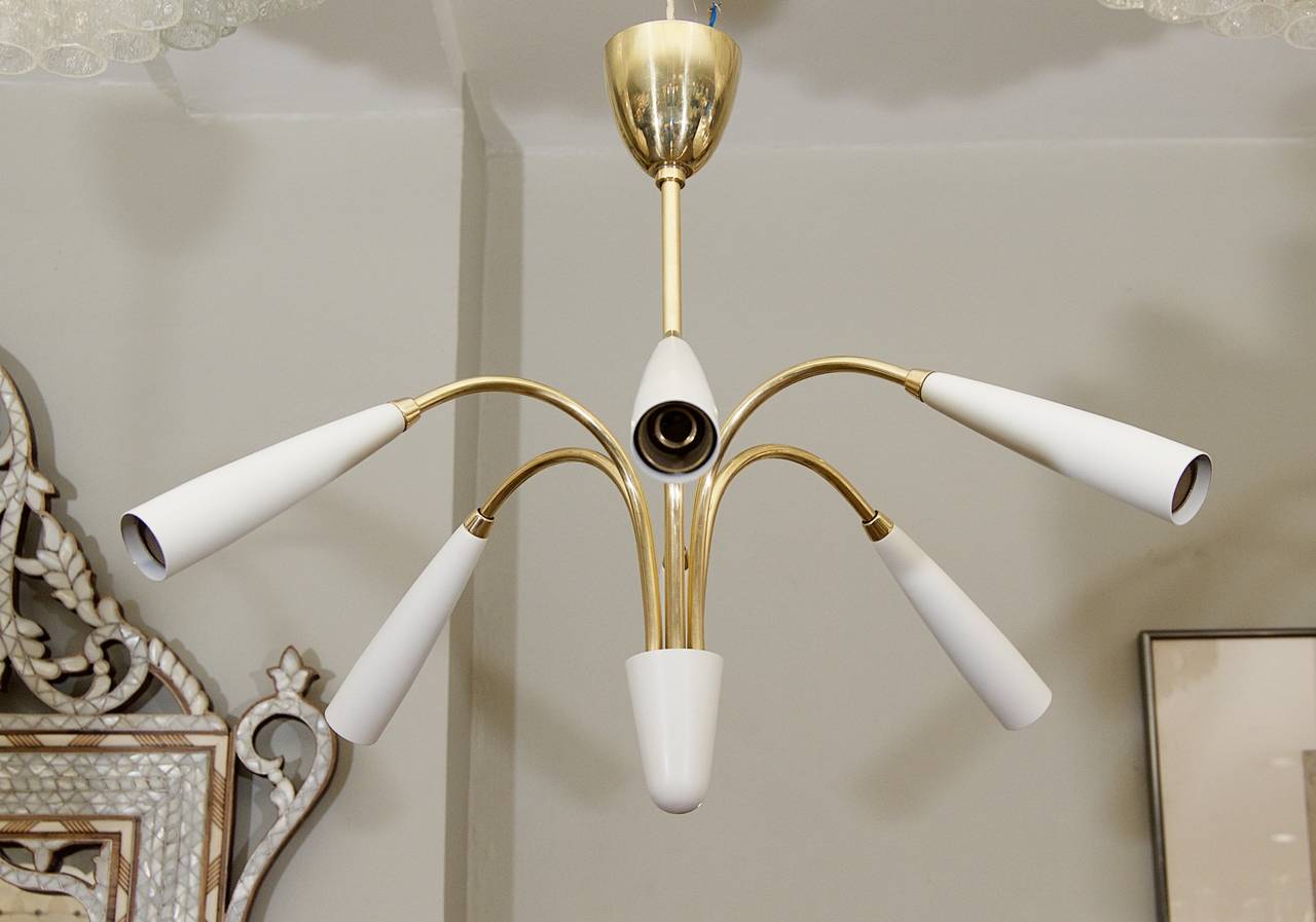 Excellent Stilnovo style chandelier in brass and white enamel.

Takes six E-14 base bulbs up to 40 watts per bulb, new wiring.

Height listed is of chandelier body only; height as currently hung is 15