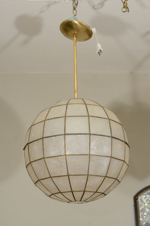 This fantastic shell globe light has that certain glow that is a  wonderful addition to all decors. Closed base conceals bulb. One 100wt bulb with brass accents.
