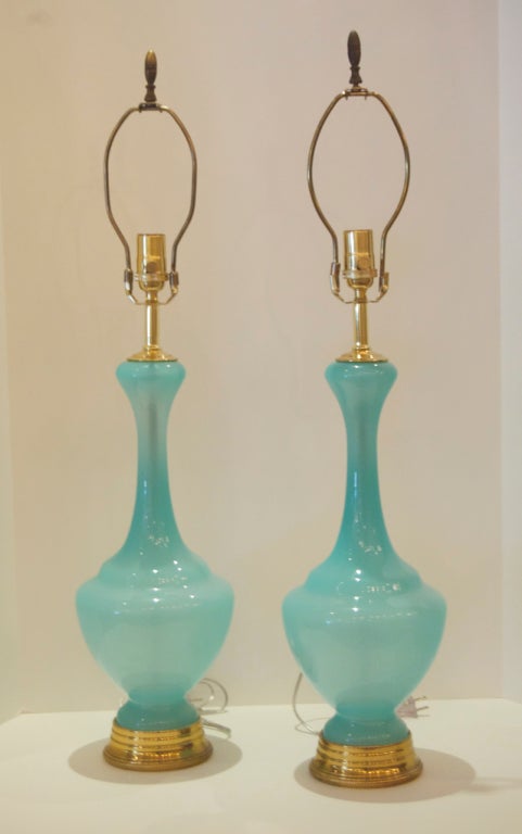 This pair of Murano glass lamps are rendered in an exquisite shade of robins egg blue.  Sure to add a note of elegance to any space. Principle height measurement is to socket, second height is to top of glass
