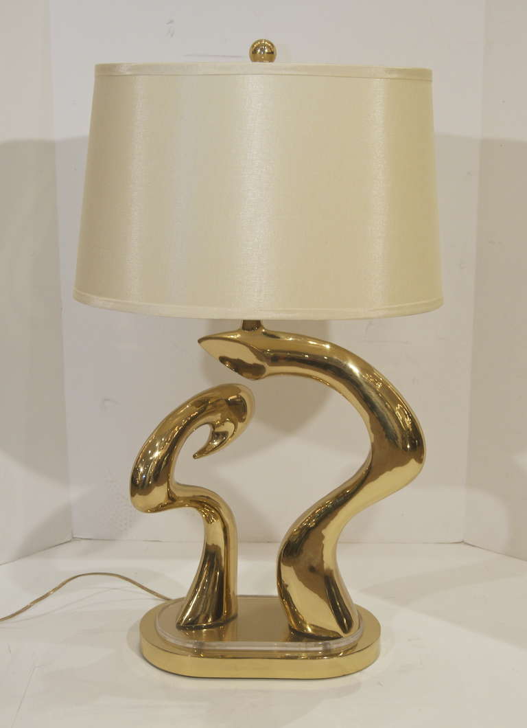 Sculptural table lamp with lucite and brass.

Takes two bulbs, up to 75 watts per bulb. Lamp shade included.

Height listed is to top of finial.