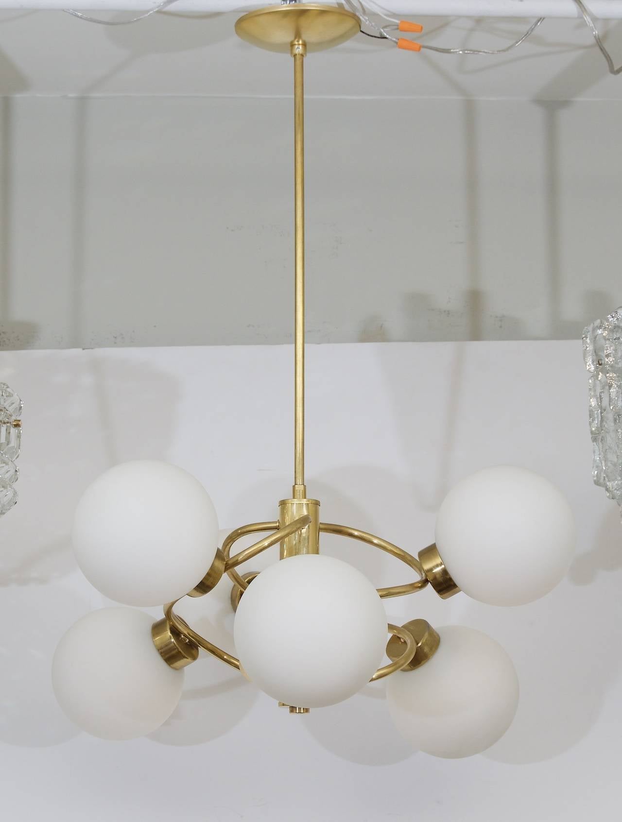 Spectacular six-arm chandelier with opal glass globes. Brass body. A wonderful addition to all decors. 

Six E14 base bulbs up to 40 watts per bulb, new wiring.