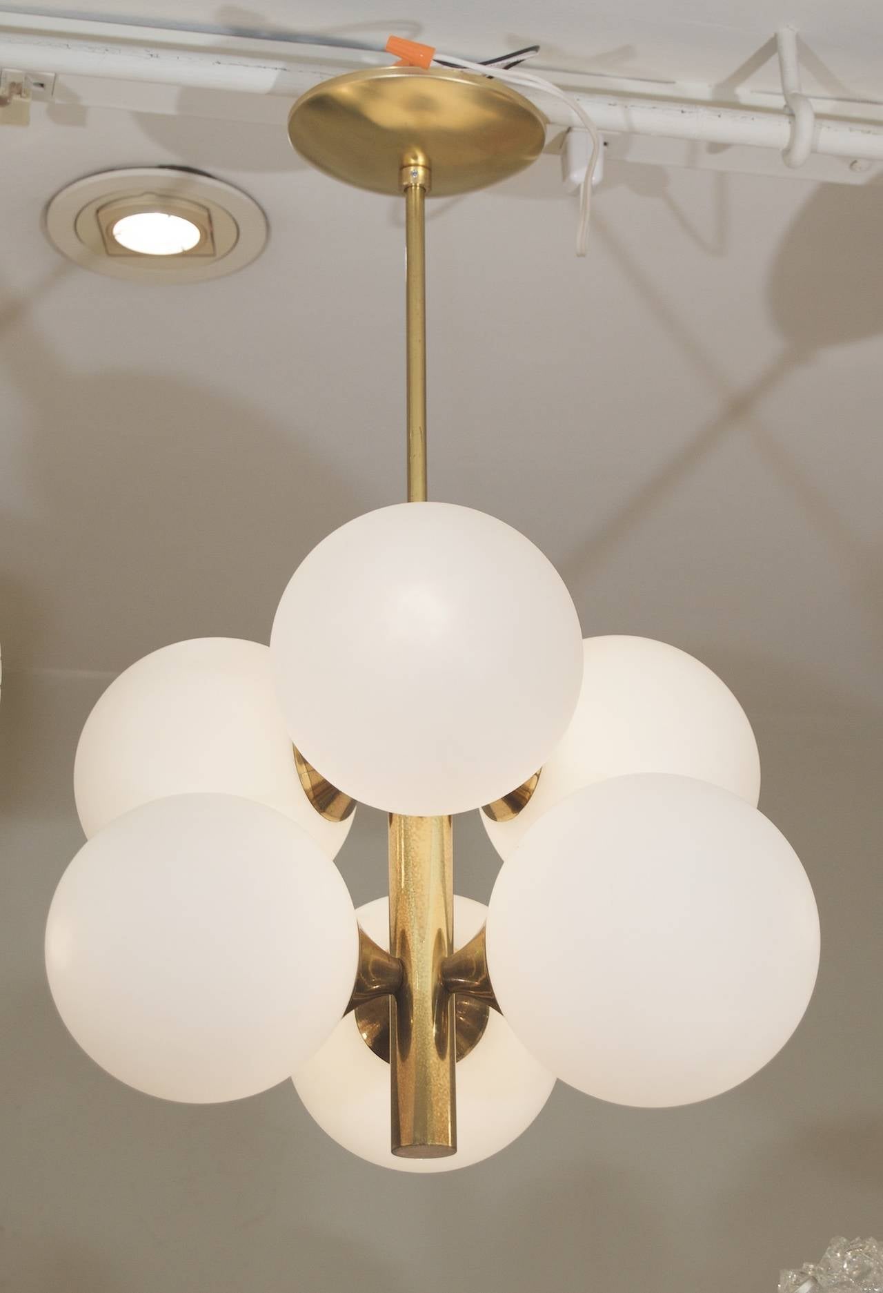 Fantastic mod light. Will update any space. Brass finish gives a warm feel.

Each globe takes a single E-14 base bulb up to 40 watts, new wiring. Pictured lit with 10 watt bulbs. New wiring.

Height is of chandelier body only; rod can be