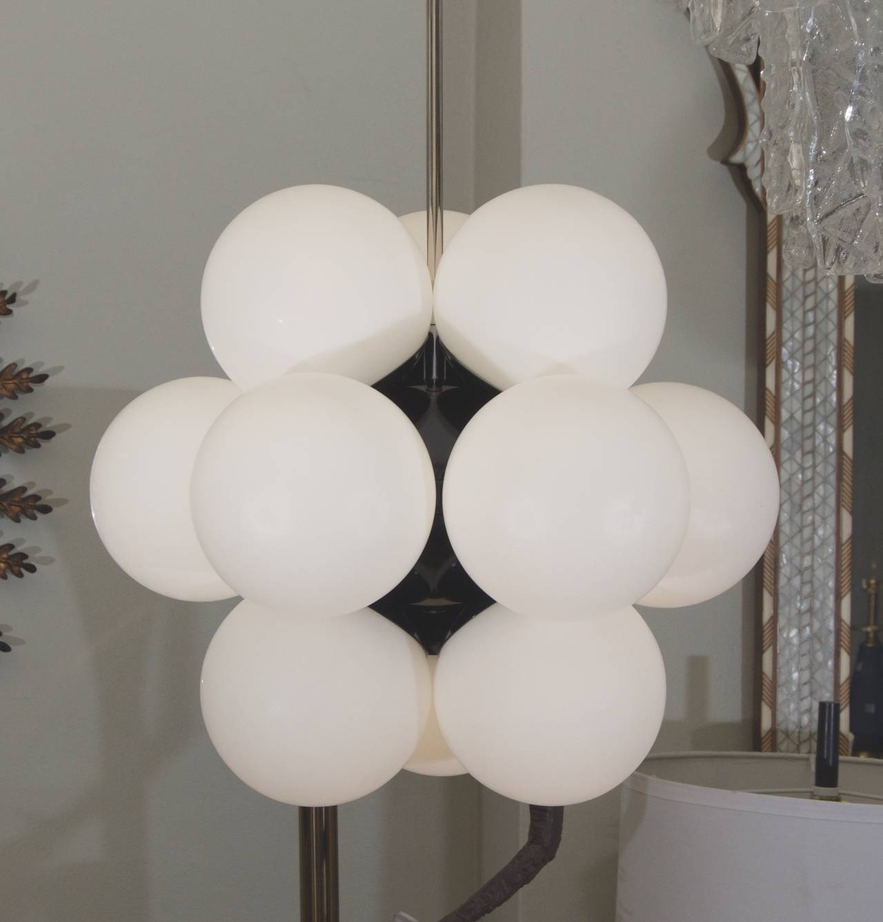 Gorgeous Kaiser chandelier with a molecular structure, much more dense visually than comparable Sputnik form chandeliers. Gloss black enamel central body is surround by 12 closely attached opal globes.

Takes 12 E-14 base bulbs, up to 40 watts per
