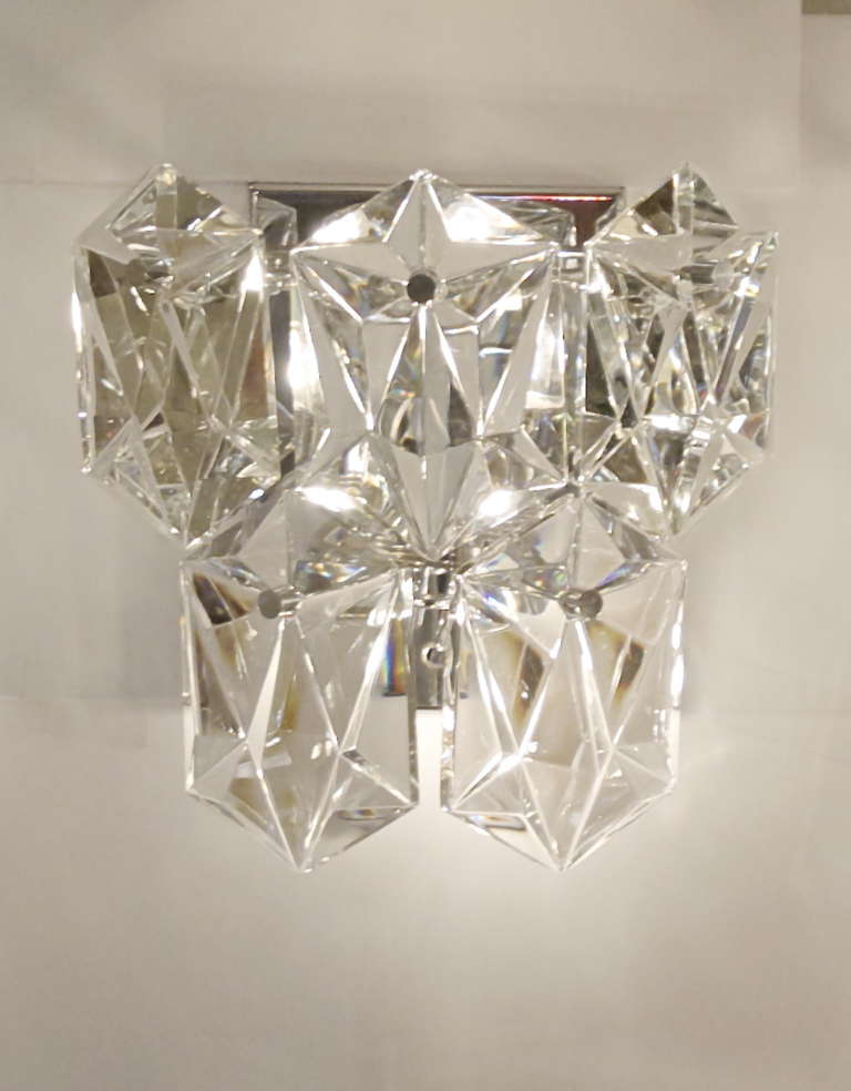 An spectacular pair of Kinkeldey wall sconces with 5 elongated hexagonal crystals each, throwing an excellent, lustrous, fire. Extreme depth of beveling on crystals is dramatic when lit.

Backplates are chrome plated.

Each takes two E-14 bulbs