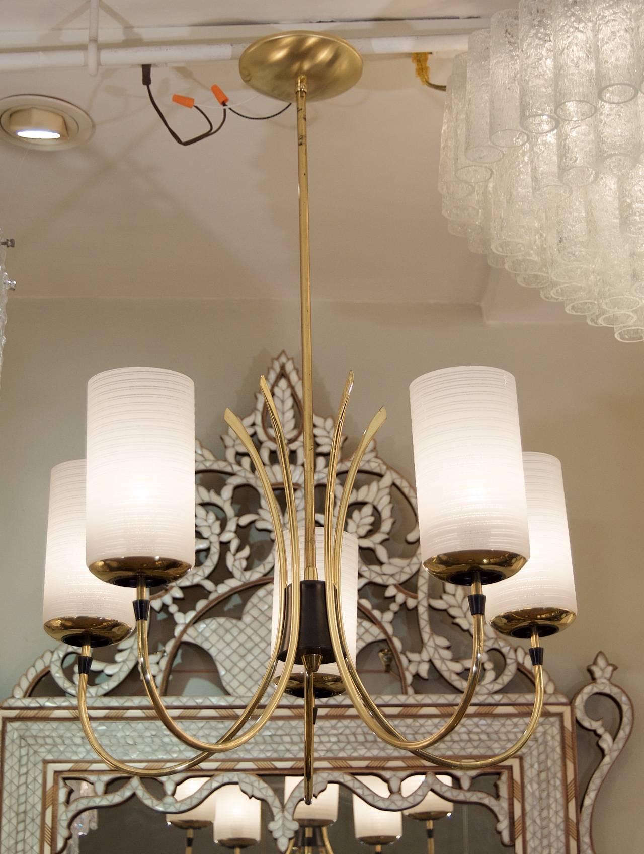 Five delicate brass arced arms each with a striped opal glass cylinder radially surrounding a black enameled cylinder to form an elegant and sophisticated chandelier.

Height listed is of chandelier body only, current height as hung is 30 inches,