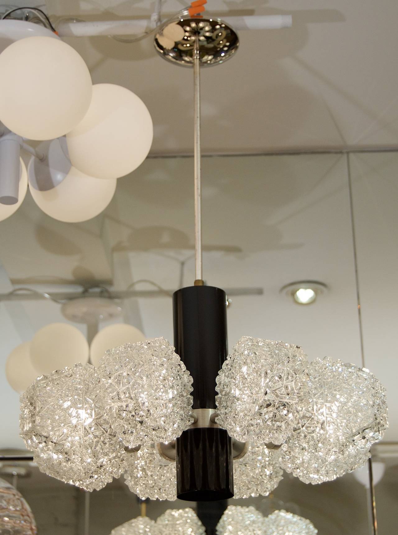 A gorgeous eight-light chandelier by Temde Leuchten with unusual hexagonal form glass covers. Brushed metal and gloss ebony finish on chandelier body.

Glass can be rotated a full 360 degrees for any arrangement of symmetric or random orientation;