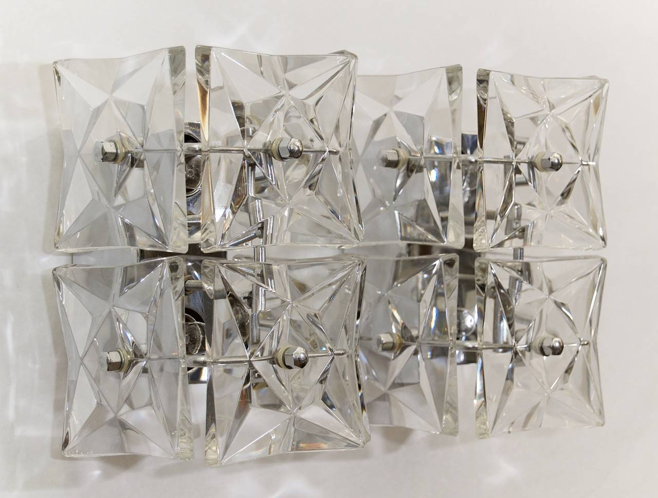 Elegant and minimal Kinkeldey sconces, each having six square crystals projecting from a central chrome body. Lustrous and bright.

Each takes two E-14 base bulbs up to 40 watts per bulb, new wiring.