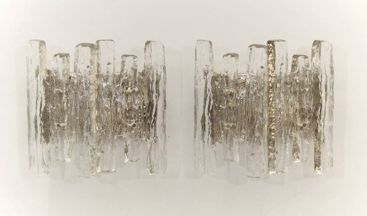 A dramatic large pair of Kalmar ice glass sconces with chrome backplates, with two large pieces of glass per sconce. Two pair available.

Matching glass pattern chandelier available in separate listing.

Takes 3 E-14 base bulbs each, up to 40