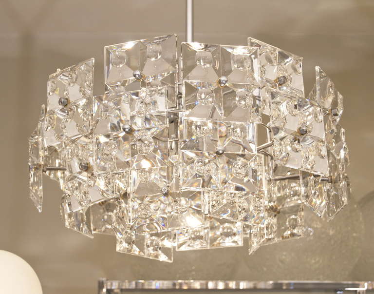Fantastic Kinkeldey chandelier with massive crystals in a staggered and overlapping structure, each crystal having a fourfold pattern of raised pyramids with a concave center. Lustrous and magnificent.

Takes six E-14 base bulbs and one medium