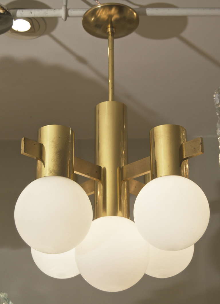 Well formed chandelier in brass, with five opal glass globes. Takes five E-12 base bulbs up to 40 watts per bulb, new wiring. Height listed is of chandelier body only, height as currently hung is 24