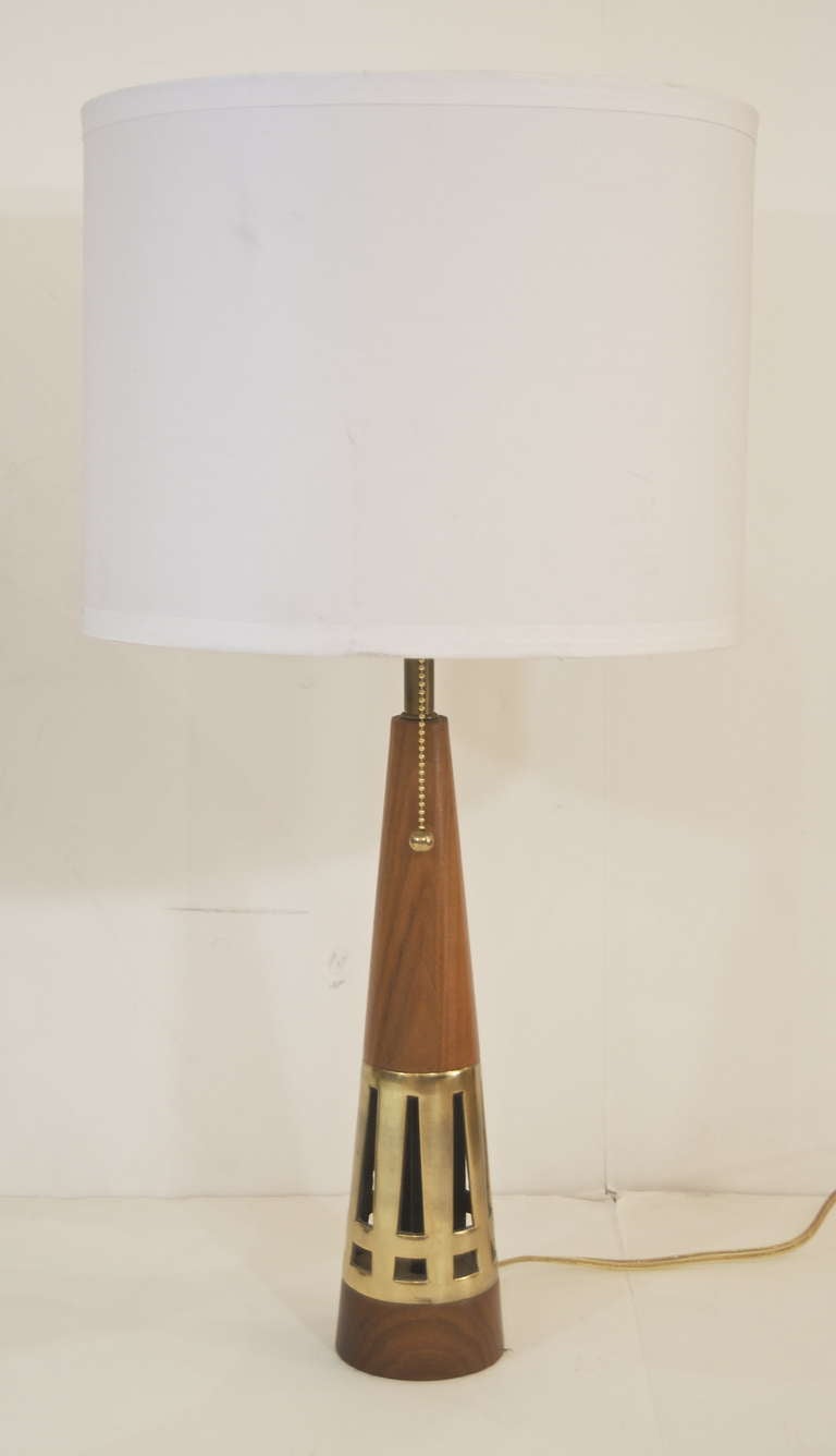 Tony Paul for Westwood lamps, the conical form of alternating wood and pierced brass, the holes in the brass recursively echoing the form of the lamp itself. New wiring, retains original harp finials.<br />
<br />
Height listed is with 9