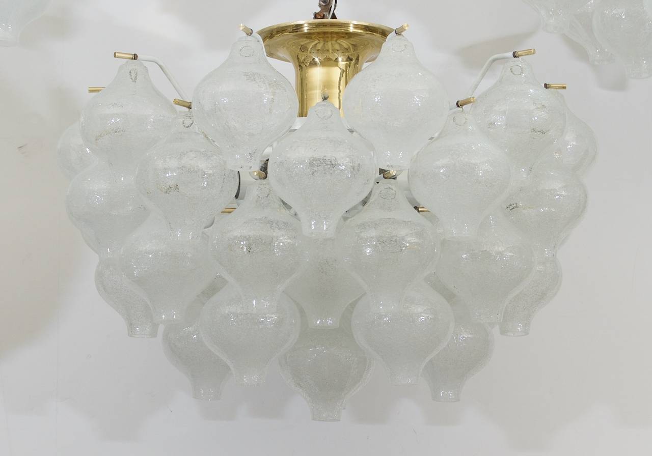 An exceptional Kalmar Tulipan glass pattern chandelier, having 41 individually hung pieces of glass. Each piece of handblown glass is wire suspended on brass pins, with the central body in enameled white.

Takes 10 E-14 base bulbs up to 40 watts