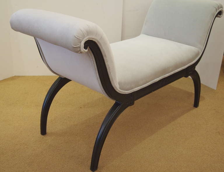 Elegant and versatile black lacquer bench newly upholstered in pale grey blue velvet.
