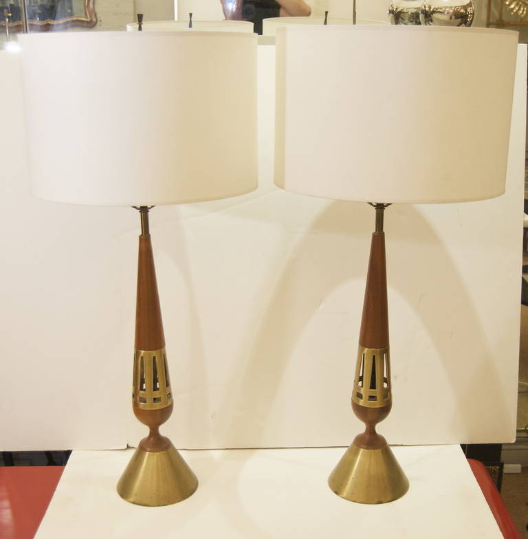 Tony Paul for Westwood lamps, the conical form of alternating wood and pierced brass on a brass base, the holes in the brass recursively echoing the form of the lamp itself. New wiring, retains original harp finials

Height listed is with 10"