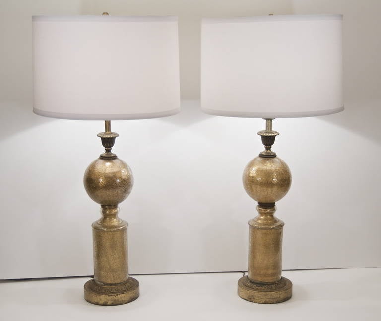 Unusual pair of table lamps, the body composed of eglomise gilt crackle glass with bronze hardware. Well proportioned and a unique design.

Height listed is with 10