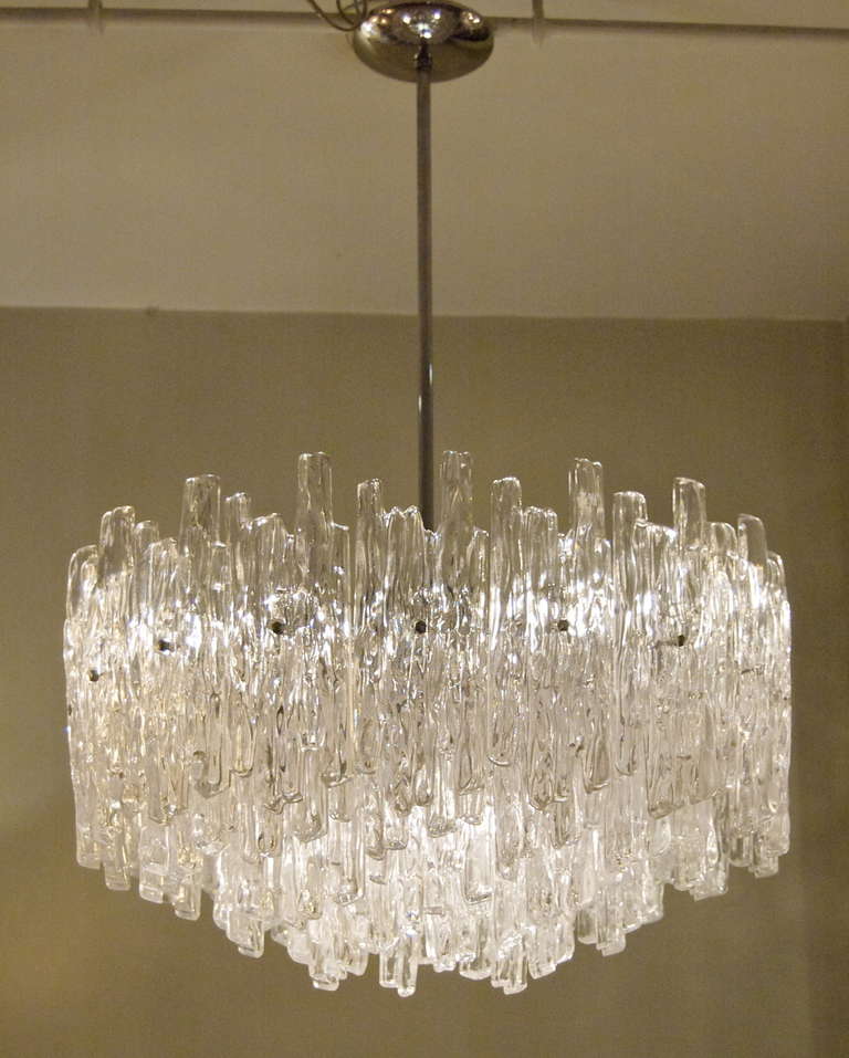 This ice lucite chandelier in the style of Kalmar is exceptionally large for its type, and is a dramatic addition to any interior. Four tiers of lucite pieces in two sizes. Well suited in scale for dining rooms.

Takes 7 medium base bulbs up to 60