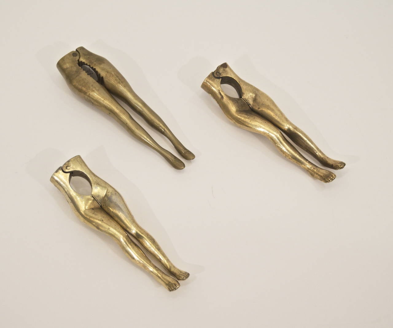 Solid brass nutcrackers in the form of elongated women's hips and legs. Early to mid 20th century design and production.

Typically of either British or Italian design, images represent inventory currently available.