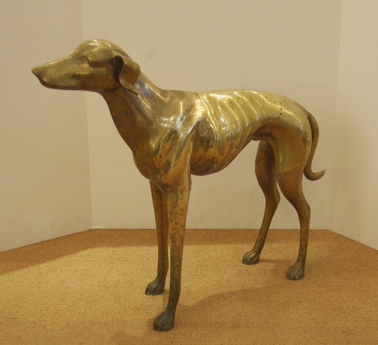 Lifesize brass dog in the form of a whippet or greyhound.