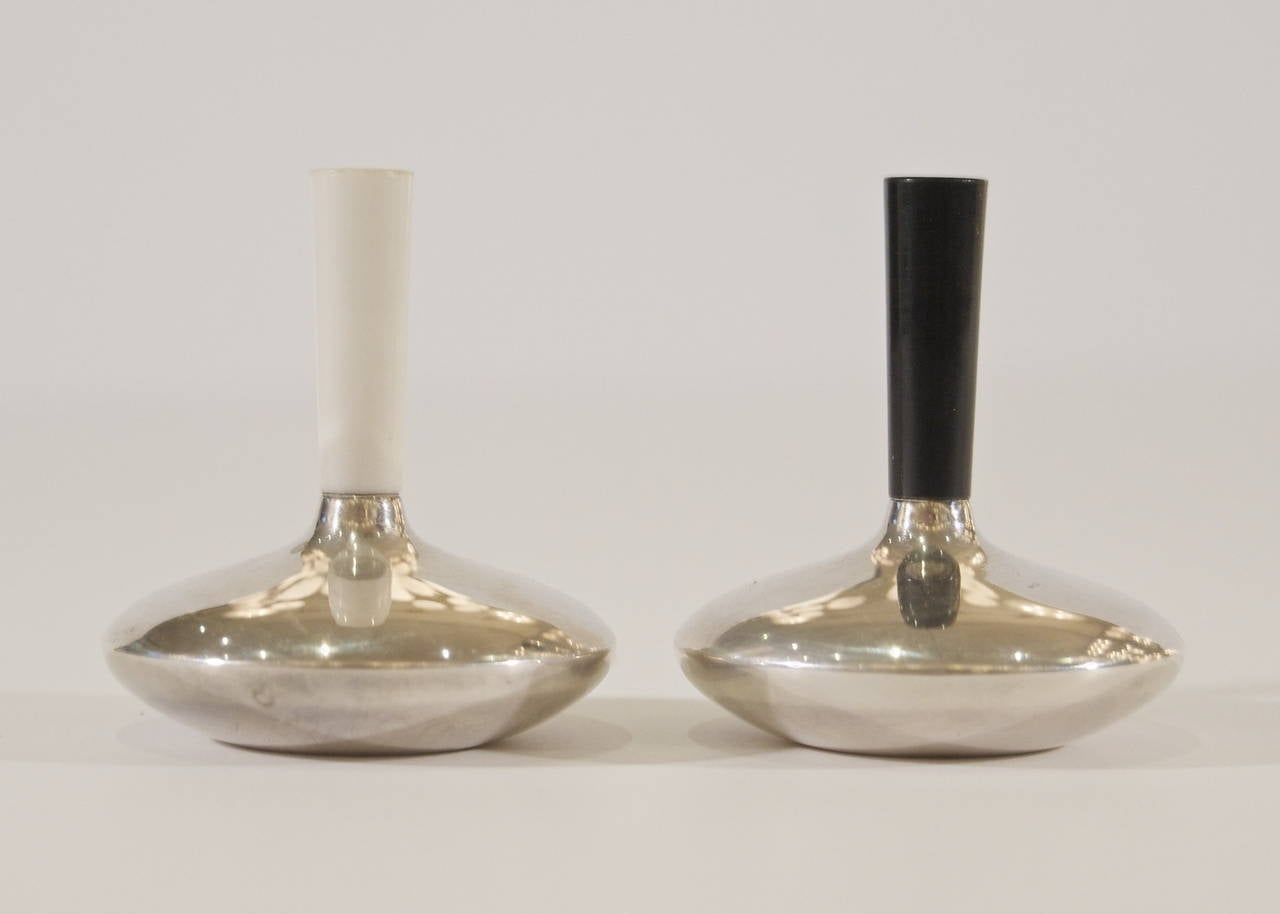 Streamlined and minimalistic formed salt & pepper shakers by Cohr, the disc body surmounted by a color-coded stem/spout.